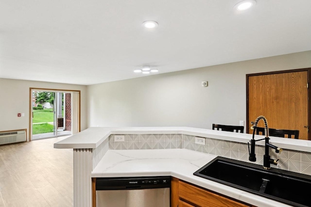 33A Grand Canyon Dr Unit 110, Baraboo, WI 53913 - kitchen with dishwasher, brown cabinetry, light wood-style floors, a wall unit AC, and recessed lighting