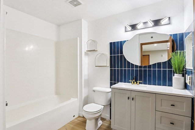 33A Grand Canyon Dr Unit 110, Baraboo, WI 53913 - full bathroom featuring vanity, wood finished floors, backsplash, and tub / shower combination