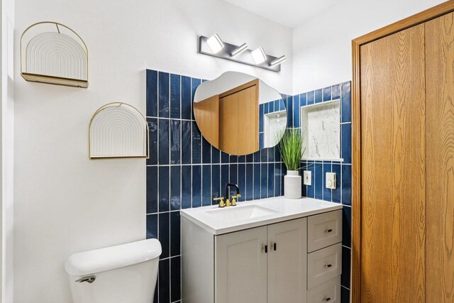 33A Grand Canyon Dr Unit 110, Baraboo, WI 53913 - bathroom featuring tile walls, vanity, and tasteful backsplash