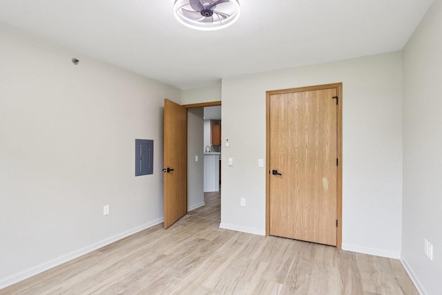 33A Grand Canyon Dr Unit 110, Baraboo, WI 53913 - unfurnished bedroom featuring electric panel and light wood-style flooring