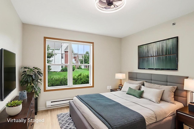 33A Grand Canyon Dr Unit 110, Baraboo, WI 53913 - bedroom featuring a baseboard radiator and light wood-type flooring