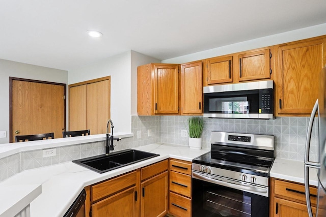 33A Grand Canyon Dr Unit 110, Baraboo, WI 53913 - kitchen with stainless steel appliances, light countertops, decorative backsplash, brown cabinets, and recessed lighting