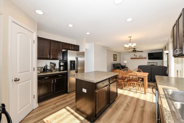 1557 Serena Ln, Burlington, WI 53105 - kitchen featuring stainless steel fridge, open floor plan, light wood-type flooring, a chandelier, and dark brown cabinetry