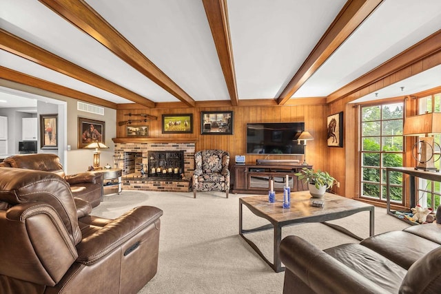 544 Maple Bluff Rd, Stevens Point, WI 54482 - carpeted living room featuring beam ceiling, wood walls, and a fireplace
