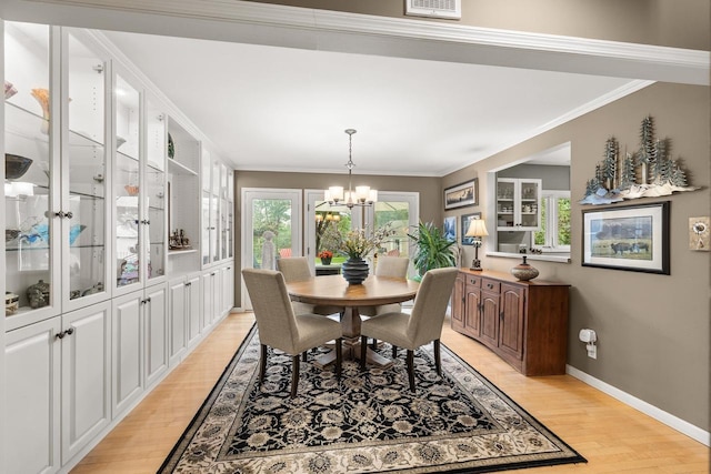 544 Maple Bluff Rd, Stevens Point, WI 54482 - dining room with a chandelier, light wood-type flooring, and ornamental molding