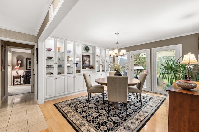 544 Maple Bluff Rd, Stevens Point, WI 54482 - dining room featuring a chandelier, ornamental molding, and light wood-style flooring