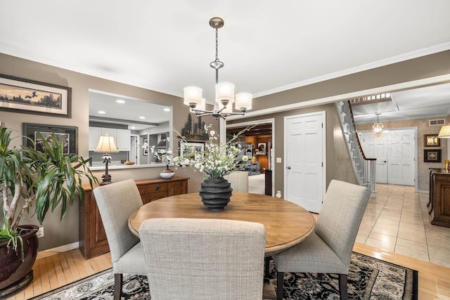 544 Maple Bluff Rd, Stevens Point, WI 54482 - dining room featuring stairs, a chandelier, and crown molding