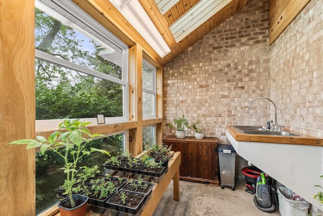 544 Maple Bluff Rd, Stevens Point, WI 54482 - indoor wet bar featuring brick wall, light colored carpet, healthy amount of natural light, and lofted ceiling
