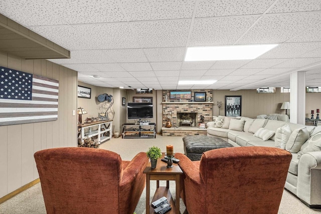 544 Maple Bluff Rd, Stevens Point, WI 54482 - living room featuring carpet flooring, a paneled ceiling, a fireplace, and wooden walls
