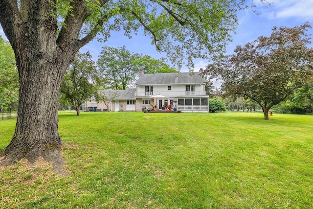 544 Maple Bluff Rd, Stevens Point, WI 54482 - back of house with a sunroom, a lawn, and a chimney