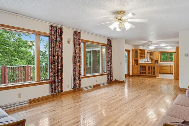 N3045 Lakeview Dr, Montello, WI 53949 - unfurnished living room with a textured ceiling, light wood-style floors, and a ceiling fan