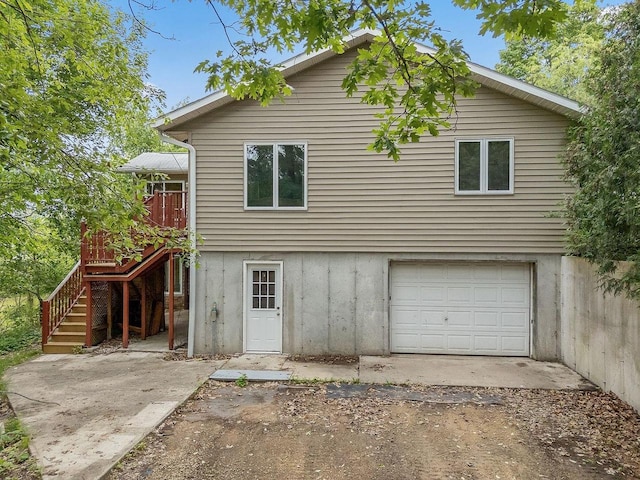 N3045 Lakeview Dr, Montello, WI 53949 - rear view of house featuring a garage, stairway, a wooden deck, and dirt driveway