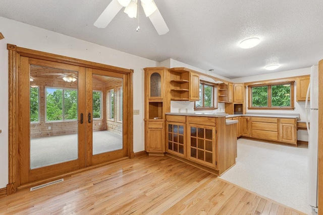 N3045 Lakeview Dr, Montello, WI 53949 - kitchen with open shelves, ceiling fan, freestanding refrigerator, light wood-type flooring, and light countertops