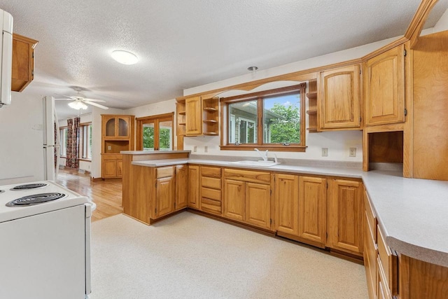 N3045 Lakeview Dr, Montello, WI 53949 - kitchen featuring open shelves, a textured ceiling, a ceiling fan, a peninsula, and white appliances