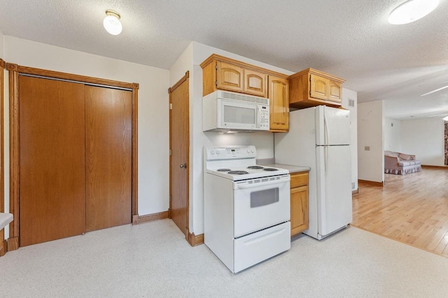 N3045 Lakeview Dr, Montello, WI 53949 - kitchen with white appliances, a textured ceiling, and light countertops