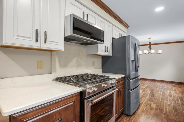 535 Maple Bluff Rd, Stevens Point, WI 54482 - kitchen featuring stainless steel appliances, white cabinetry, ornamental molding, light countertops, and wood finished floors