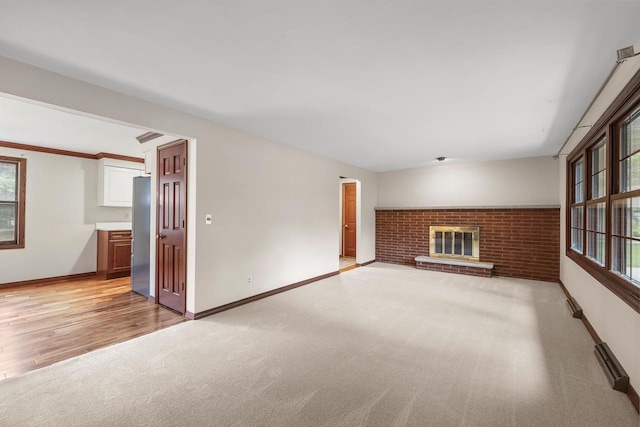 535 Maple Bluff Rd, Stevens Point, WI 54482 - unfurnished living room with light carpet, plenty of natural light, and a fireplace