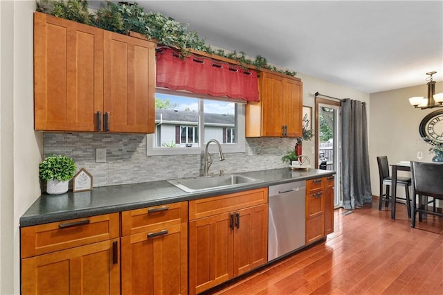 1516 Mitscher Ave, Eau Claire, WI 54701 - kitchen featuring stainless steel dishwasher, wood finished floors, backsplash, and plenty of natural light