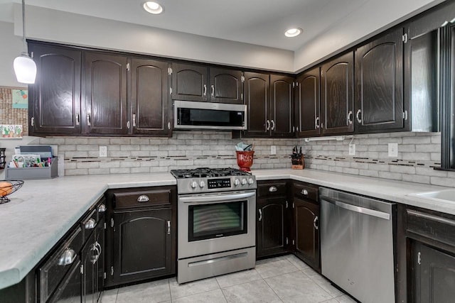 1801 N Mc Intosh Dr, Appleton, WI 54914 - kitchen with stainless steel appliances, light tile patterned floors, backsplash, light countertops, and dark brown cabinetry