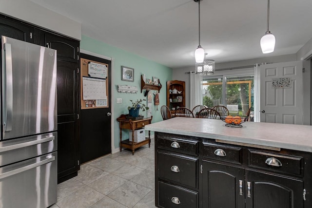 1801 N Mc Intosh Dr, Appleton, WI 54914 - kitchen with freestanding refrigerator, dark cabinets, light tile patterned floors, and light countertops