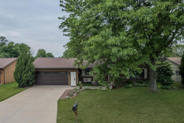 1801 N Mc Intosh Dr, Appleton, WI 54914 - view of front of house featuring an attached garage, driveway, a front lawn, and a shingled roof