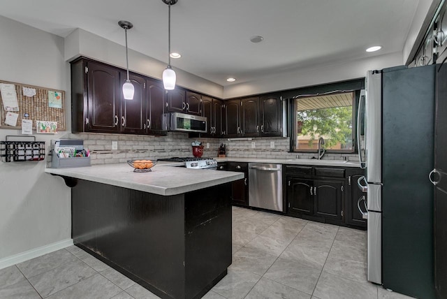 1801 N Mc Intosh Dr, Appleton, WI 54914 - kitchen featuring stainless steel appliances, a peninsula, decorative backsplash, light countertops, and light tile patterned floors