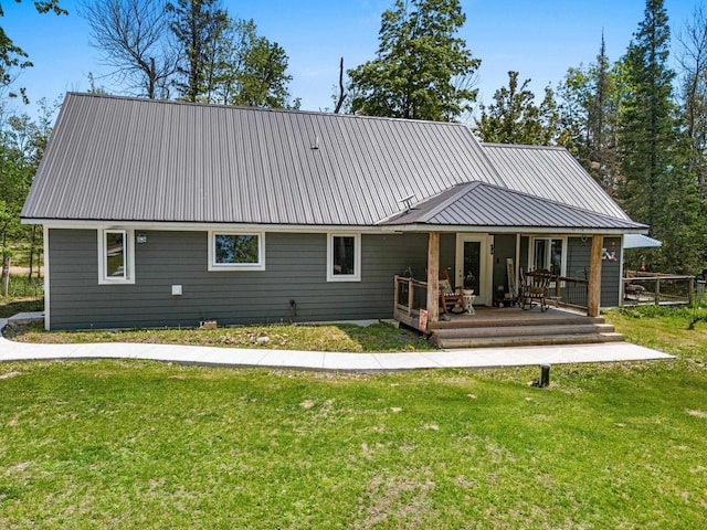 9071 Doemel Ln, Pickerel, WI 54465 - back of property featuring a lawn, a metal roof, and covered porch