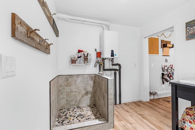 9071 Doemel Ln, Pickerel, WI 54465 - hall featuring tankless water heater and light wood finished floors
