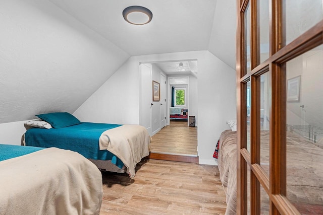 9071 Doemel Ln, Pickerel, WI 54465 - bedroom with light wood-style flooring and lofted ceiling