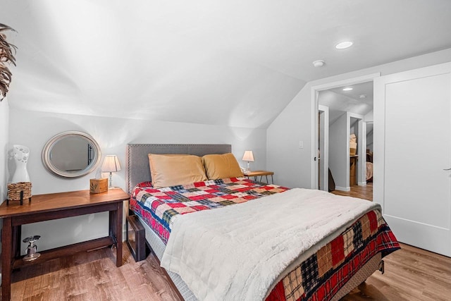 9071 Doemel Ln, Pickerel, WI 54465 - bedroom featuring wood finished floors, vaulted ceiling, and recessed lighting