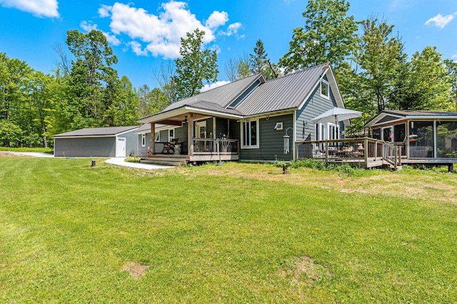 9071 Doemel Ln, Pickerel, WI 54465 - view of front of home with a front lawn, a metal roof, a sunroom, a wooden deck, and a porch