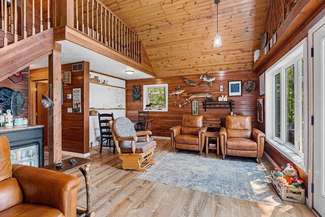 9071 Doemel Ln, Pickerel, WI 54465 - living area featuring wood walls, wood finished floors, high vaulted ceiling, a fireplace, and wooden ceiling