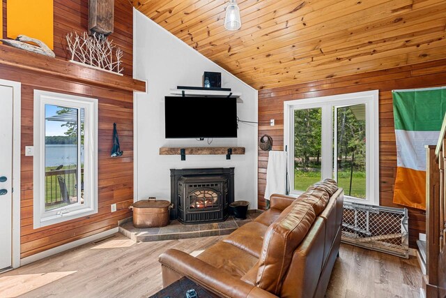 9071 Doemel Ln, Pickerel, WI 54465 - living area with lofted ceiling, wood walls, wood finished floors, wooden ceiling, and a wood stove