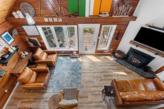 9071 Doemel Ln, Pickerel, WI 54465 - living area with wooden walls, wood finished floors, and a lit fireplace