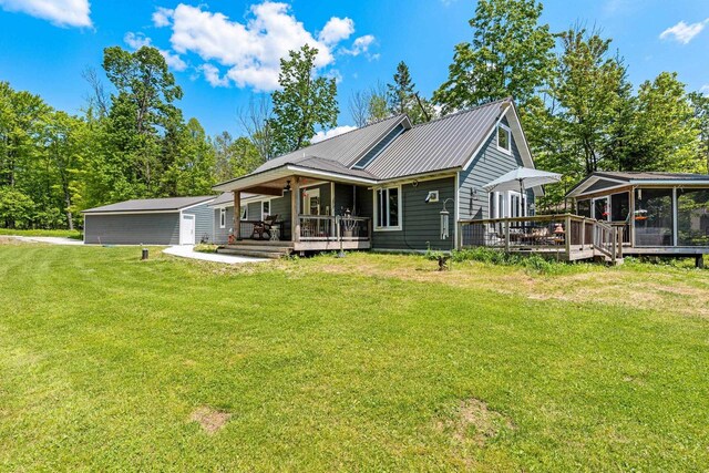 9071 Doemel Ln, Pickerel, WI 54465 - view of front of home with a front lawn, a metal roof, a sunroom, a wooden deck, and a porch