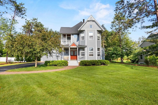 1020 Victorian Ln, Plover, WI 54467 - view of front of property with asphalt driveway, a front lawn, french doors, and a garage