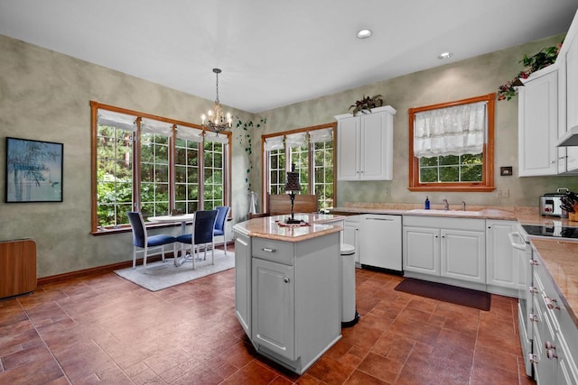 1020 Victorian Ln, Plover, WI 54467 - kitchen featuring white appliances, a center island, a chandelier, white cabinets, and decorative light fixtures
