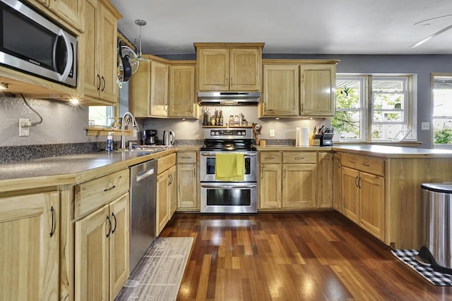 3933 Lovers Ln Unit 3935, 3937, 3939, 39, Slinger, WI 53086 - kitchen with stainless steel appliances, under cabinet range hood, light brown cabinets, dark wood-style floors, and a peninsula