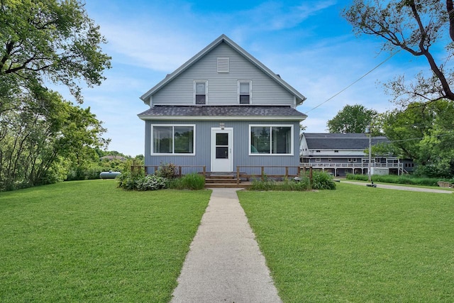 3933 Lovers Ln Unit 3935, 3937, 3939, 39, Slinger, WI 53086 - view of front facade featuring roof with shingles and a front yard