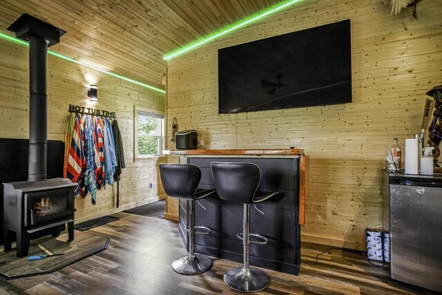 3933 Lovers Ln Unit 3935, 3937, 3939, 39, Slinger, WI 53086 - bar area with a wood stove, wood walls, dark wood-style flooring, wood ceiling, and freestanding refrigerator