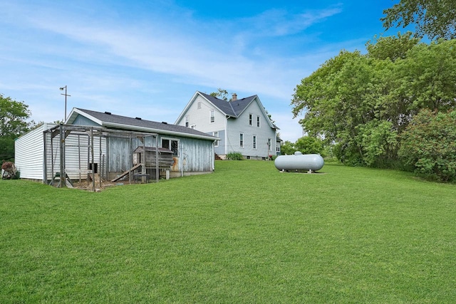 3933 Lovers Ln Unit 3935, 3937, 3939, 39, Slinger, WI 53086 - rear view of property with exterior structure, a lawn, and an outbuilding