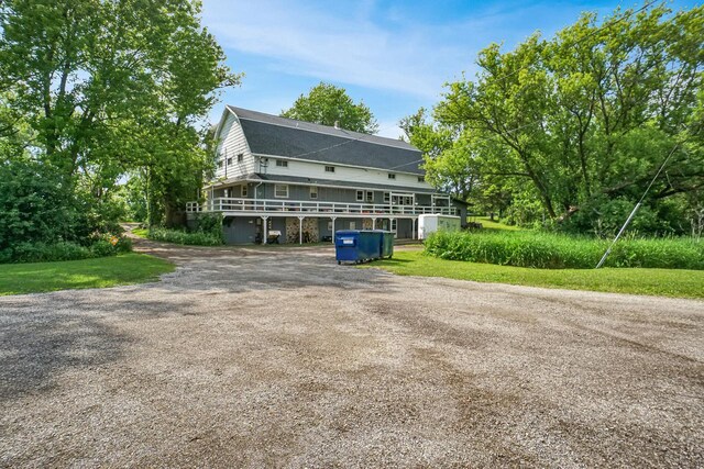 3933 Lovers Ln Unit 3935, 3937, 3939, 39, Slinger, WI 53086 - view of front of home featuring driveway and a wooden deck