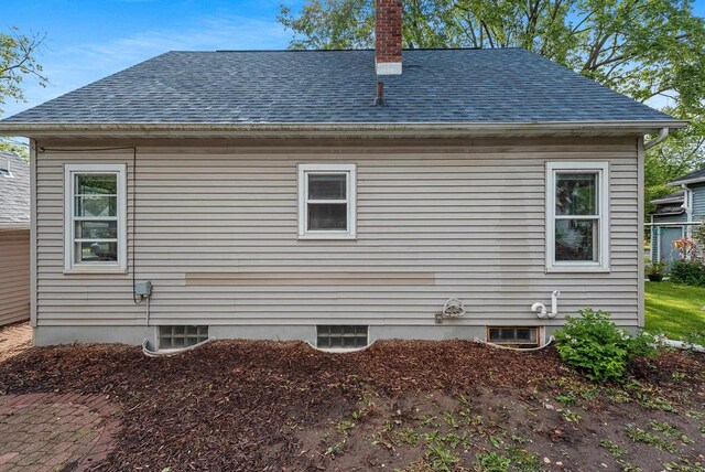 210 S Summit St, Appleton, WI 54914 - view of side of property featuring roof with shingles and a chimney