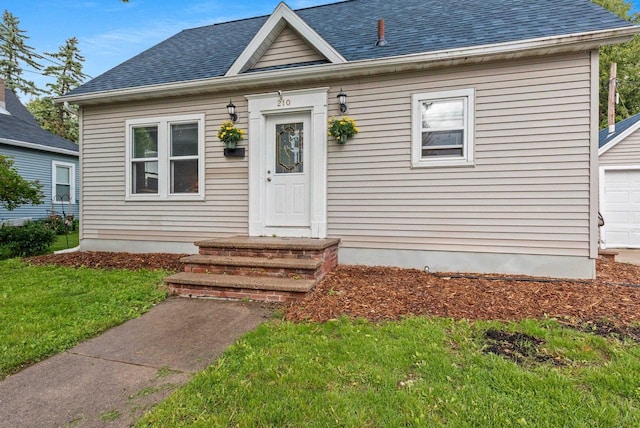 210 S Summit St, Appleton, WI 54914 - view of front of home featuring a shingled roof, a garage, and a front yard