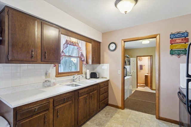 197 Juniper Ave, Brodhead, WI 53520 - kitchen with light countertops, backsplash, stainless steel range oven, and dark brown cabinets