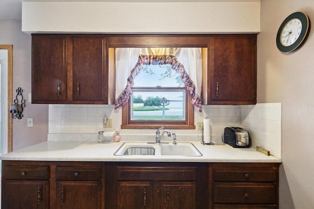 197 Juniper Ave, Brodhead, WI 53520 - kitchen featuring backsplash, light countertops, and dark brown cabinets