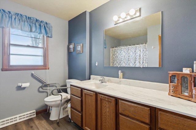 197 Juniper Ave, Brodhead, WI 53520 - bathroom featuring vanity, a baseboard radiator, wood finished floors, and a shower with curtain