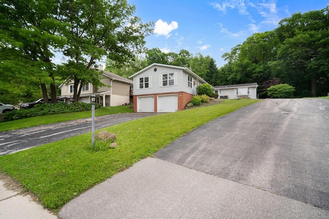 2560 Pebble Valley Rd, Waukesha, WI 53188 - view of front facade featuring driveway, a garage, a front yard, and brick siding