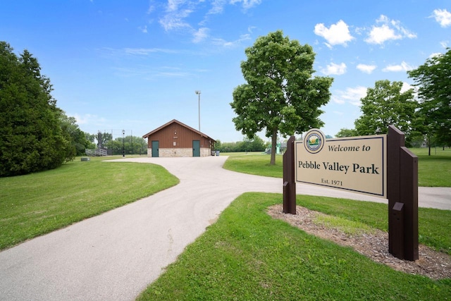 2560 Pebble Valley Rd, Waukesha, WI 53188 - surrounding community with a lawn, driveway, and a garage