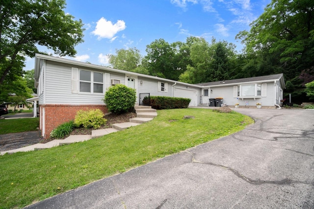 2560 Pebble Valley Rd, Waukesha, WI 53188 - view of front of home featuring brick siding, a front lawn, an attached garage, and driveway